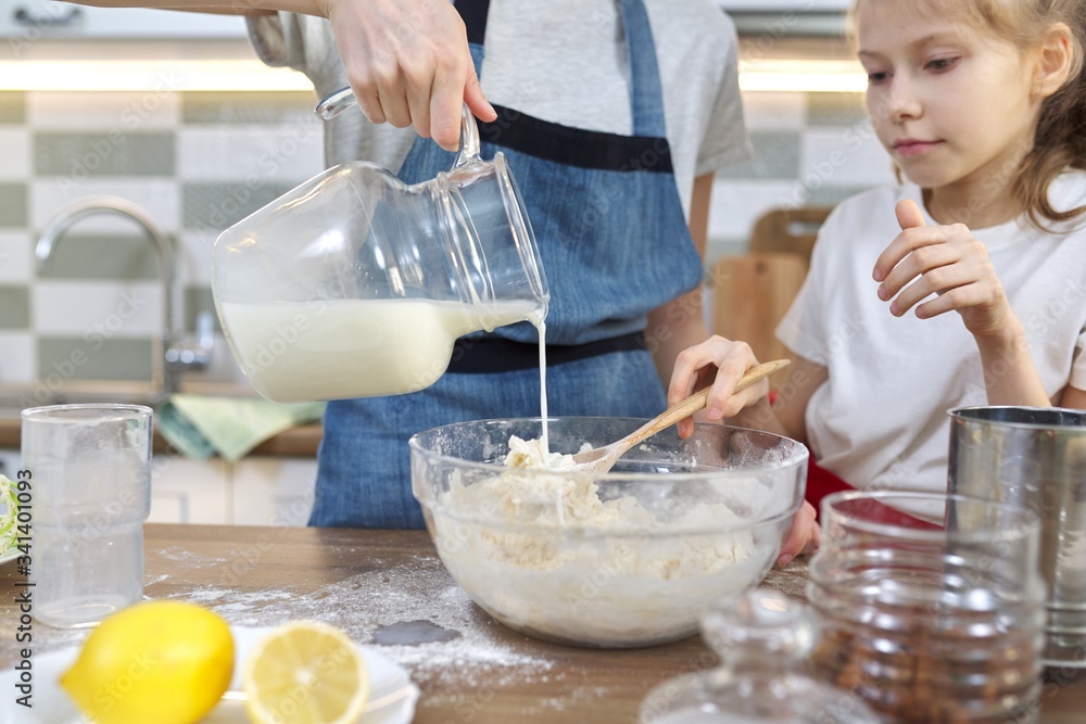 Wall mural children mix the flour in bowl, pour milk in dough