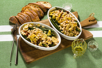 Cannellini nutritious white bean salad with green beans, sun-dried tomatoes and artichokes in oil. Traditional italian food