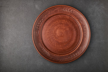 ceramic brown plate on a black stone countertop