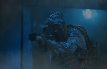 Special forces. soldier assault rifle with silencer. sniper in the forest. 