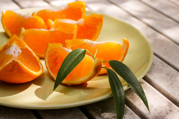 Fresh orange served outside in garden on white table  in sun lights close up