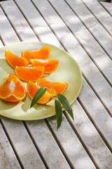 Fresh orange served outside in garden on white table  in sun lights close up