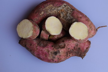 Fresh sweet potatoes isolated on white background
