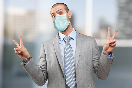 Man doing victory sign with both hands during coronavirus pandemic