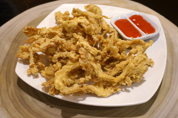 Fried Crispy mushroom on wooden table.