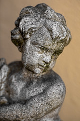 Fototapeta na wymiar stone figure of a child against blurred background