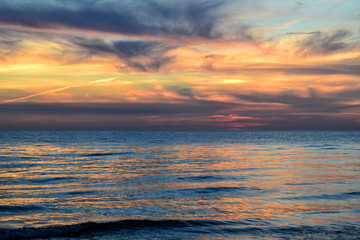 Baltic sea. Colourful sunset at the end of the day with clouds reflection on the water.