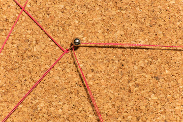 Red threads lead to a metal pin