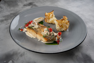grilled salmon dish. grey backgroound