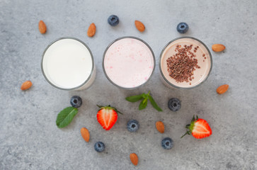 Assorted protein cocktails with fresh fruits, berries and chocolate. Protein shake. Sports nutrition and healthy lifestyle concept. Top view.