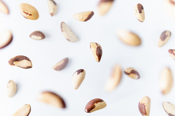 Shelled Brazil nuts flying above white background, levitation effect