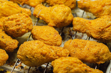 Southern crispy battered fried chicken wings, deep-fried chicken wings on the metal tray