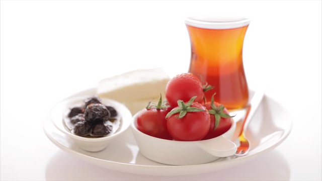 Turkish tea, simit, tomato, olive, cheese on isolated white background