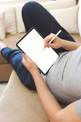 Male using stylus on tablet to draw