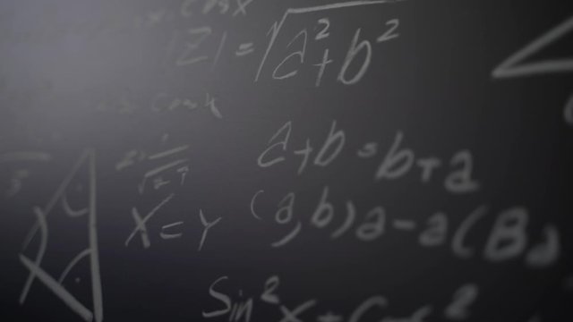 Slow motion close up a math formulas on chalkboard with white chalk.