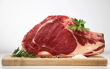 Rolgordijnen Raw T Bone steak on wooden board prepared to Grill  © FreeProd