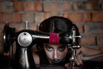 A brunette girl with creative make-up looks through black lace and shows different emotions....