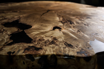 Wood surface cross section of elm tree. Live slab texture. Solid elm wooden table with epoxy resin filling. Wood countertop. Woodworking, carpentry, furniture production. Shallow depth of field.
