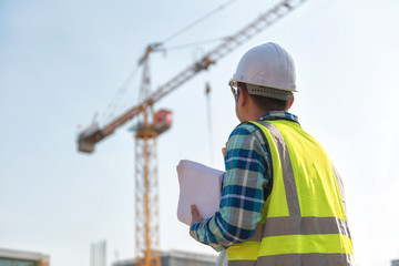 Civil engineer inspects work using radio communication with the management team in the construction...