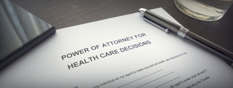 A Power Of Attorney On The Desk. Pen, Smartphone And Power Of Attorney For Health Care Decision Form On The Table.