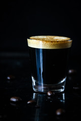 Espresso shot on black background 