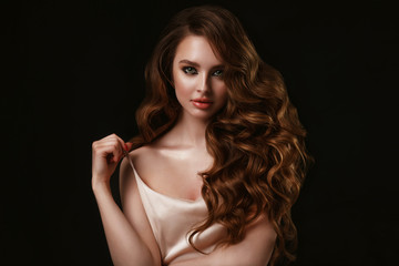 Beauty portrait of elegant young woman. Glamour makeup. Face of the beautiful woman with long brown...