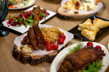 
meat with greens and tomatoes on a plate
