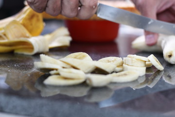 Slicing bananas. Making Boston Banoffee Pie.