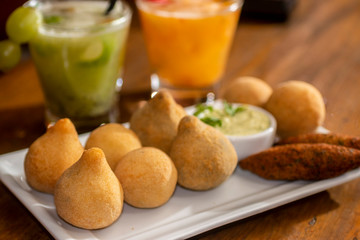 Coxinha de frango on bar table. Typical brazilian fry snack of chicken.