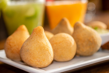 Coxinha de frango on bar table. Typical brazilian fry snack of chicken.