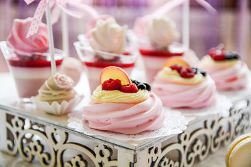 Wedding Dessert Buffet.Cupcake with swirls and flower of creamy.Sweet cookie decoration and details