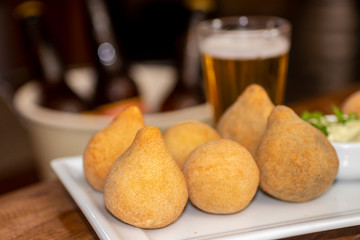 Coxinha de frango on bar table. Typical brazilian fry snack of chicken.