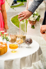 Wedding traditions. A full glass of cereals. Wheat, beans, bread and honey.