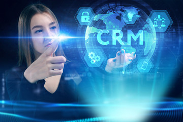 Business, Technology, Internet and network concept. Young businessman working on a virtual screen of the future and sees the inscription: CRM