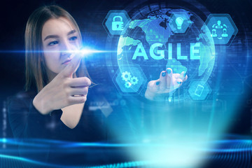 Business, Technology, Internet and network concept. Young businessman working on a virtual screen of the future and sees the inscription: Agile