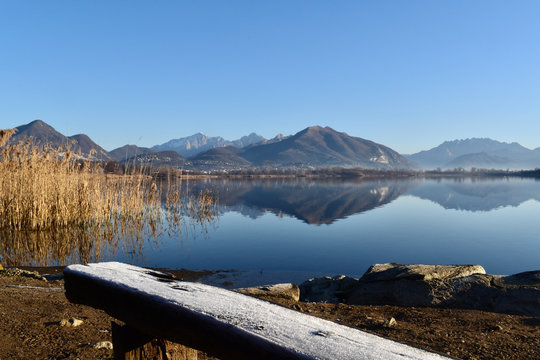 Alserio lake Como Italy - mountain reflected on the water - blue sky - Lago di Alserio
