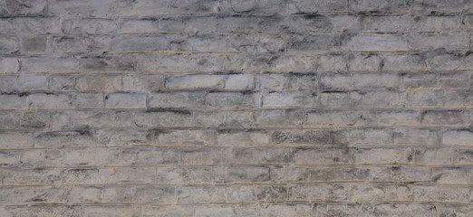 Brick wall texture, background in white oldstyle color. Uneven brickwork and wall, painted with...