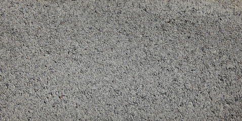 Grey grainty surface. Cinder block wall, texture and background. The fragment of a slag (cinder) blocks or expanded brickwork. Old-fashion colors of exterior and building materials