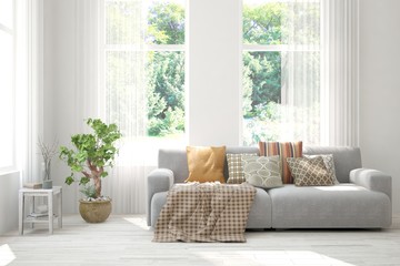 White living room with sofa and summer landscape in window. Scandinavian interior design. 3D illustration