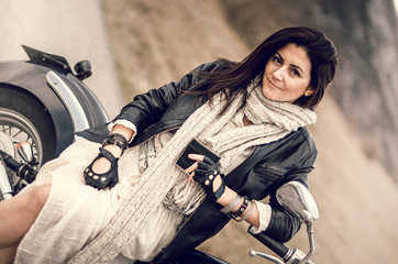 Young woman on a motorcycle on the roud 