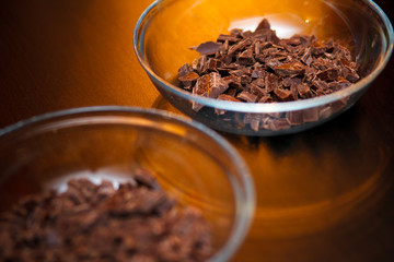 Glass bowl full of crushed chocolate for baking a brownie