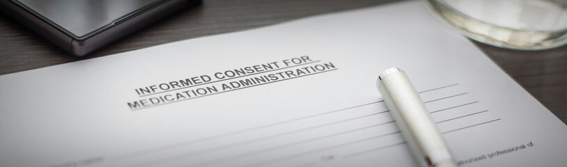 informed consent for medical administration form on the table.