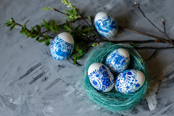 Easter eggs in a nest on a gray background.