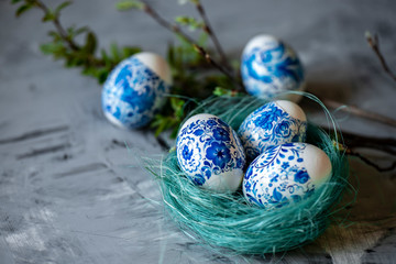 Easter eggs in a nest on a gray background.