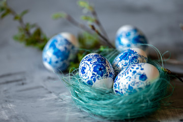 Easter eggs in a nest on a gray background.
