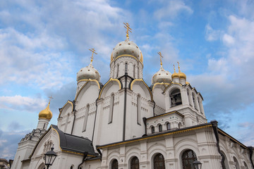 Fototapeta na wymiar Zachatyevsky Monastery Katholikon in Ostozhenka district, Moscow, Russia. Nativity of Virgin Mary Cathedral. Orthodox church and blue cloudy sky. 