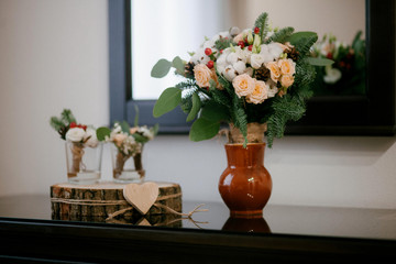 
wedding rings on a wooden stand with a bouquet