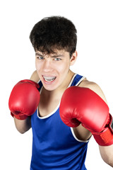 Teenage sportsman in boxing gloves and clothing with special protection on teeth against blows on a...