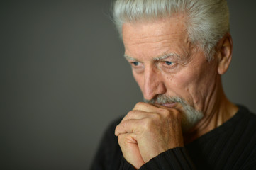 Portrait of thoughtful senior man at home