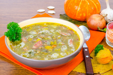 Soup from pumpkin, lentil and sausage. Photo